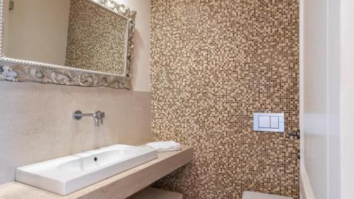 a bathroom with a sink and a mirror at Villa Panorama 14, Emma Villas in Chianni