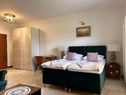 a bedroom with a bed with towels on it at Red Barn in Spała