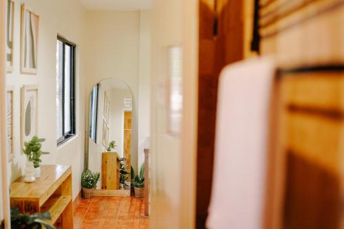 a hallway with potted plants and a mirror at Pallet Homes - Petalsville in Iloilo City