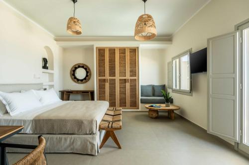 a bedroom with a king sized bed and a chair at Oia Lia in Oia