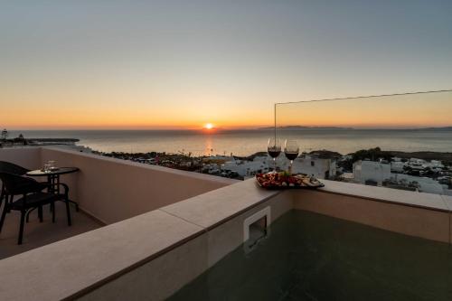a view of the sunset from the balcony of a hotel at Oia Lia in Oia