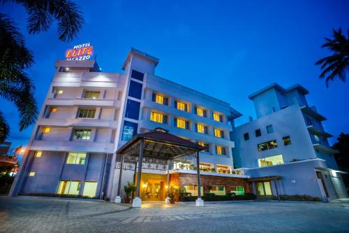 a hotel with a sign on the top of it at Hotel Elite Palazzo in Kāladi