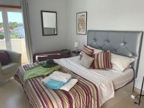 a bedroom with a large bed with towels on it at Cabanas Beach Penthouse in Cabanas de Tavira
