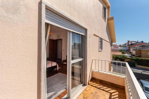 a balcony with sliding glass doors on a building at Cantinho alegre em Cascais in Cascais
