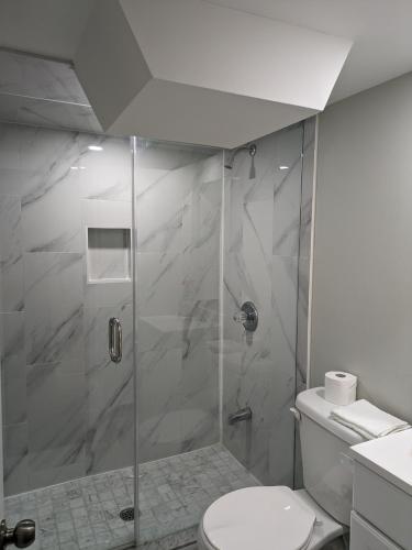 a bathroom with a shower with a toilet at Stunning Furnished 2 Bedroom 2 Washroom Basement Apartment in Brampton