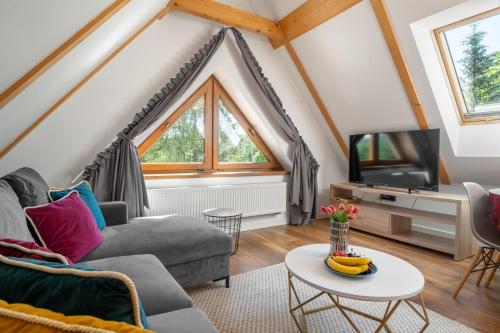 a living room with a couch and a tv at WILLA JAROSTA & SPA, AC -free parking in Zakopane