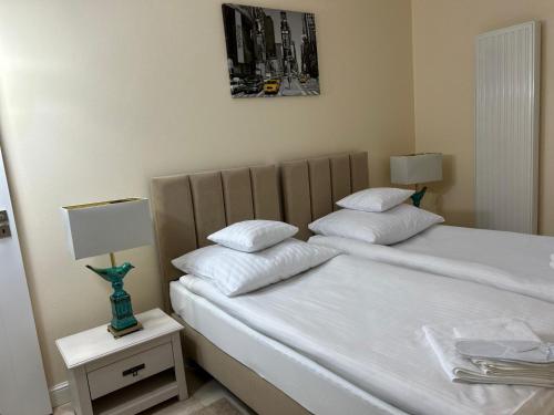 a bedroom with two beds with white pillows at Red Barn in Spała