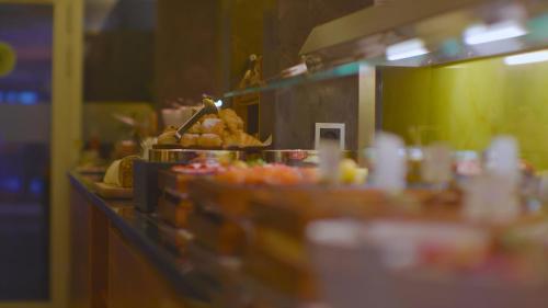 a kitchen with a counter with food on it at Hotel Raphael im Allgäu in Kempten