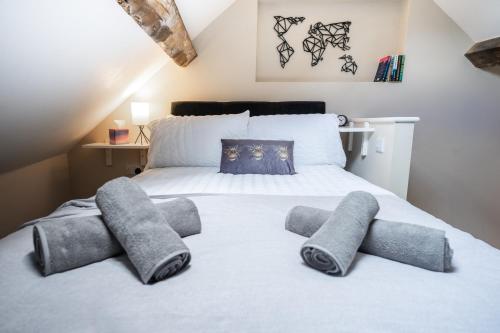 a bedroom with a bed with four pillows on it at Sunday School House in Shrewsbury