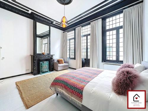 a bedroom with a bed and a fireplace at Le Cœur D'Anvers - Architectural Townhouse in Antwerp
