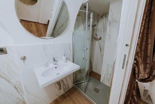 a bathroom with a sink and a shower at La casa di Achille in Chieti