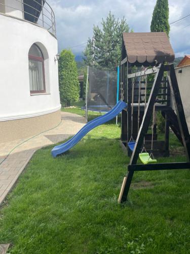 a playground with a slide in the grass at Royal Boutique in Râşnov