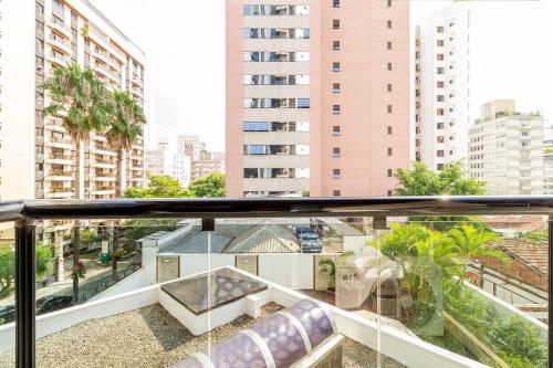 an apartment balcony with a view of a city at H4 Fortune Jardins in Sao Paulo