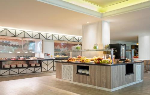 a restaurant with a buffet of food on a counter at Sol Katmandu Park & Resort in Magaluf