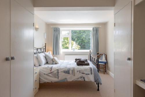 a bedroom with a bed and a window at St Elmo in Southwold