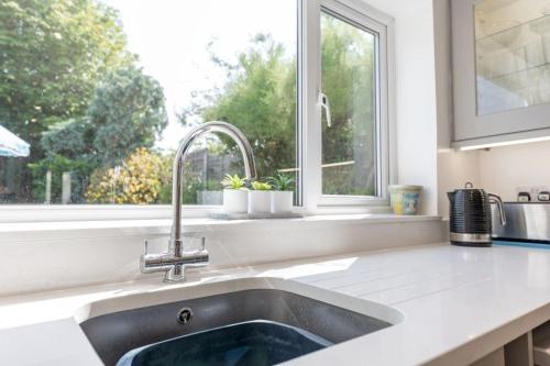 a kitchen with a sink and a window at St Elmo in Southwold