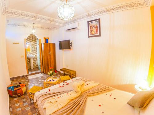 a bedroom with two beds and a mirror at Riad Dar Yassine in Marrakech