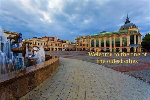 a building with a water fountain in front of a building at Belona Hotel in Kutaisi