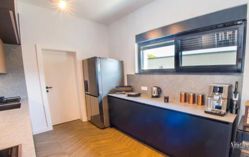 a kitchen with a counter and a refrigerator at Villa River in Mostar