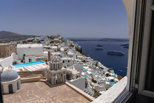 a view of a city from a balcony of a building at Villa Ilias in Firostefani