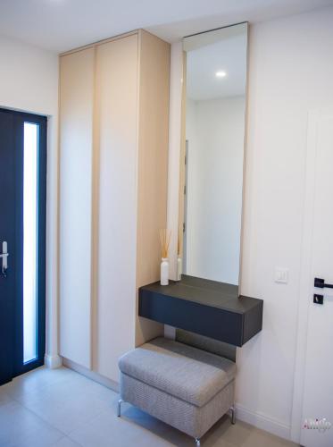 a dressing room with a stool and a mirror at Villa River in Mostar