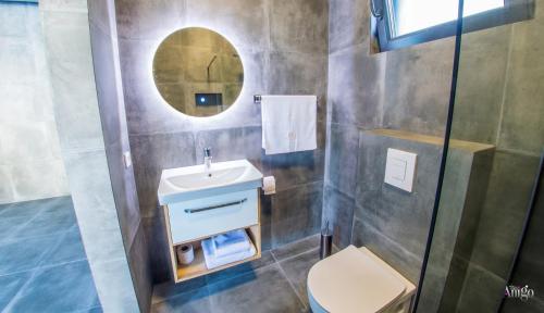 a bathroom with a sink and a mirror at Villa River in Mostar