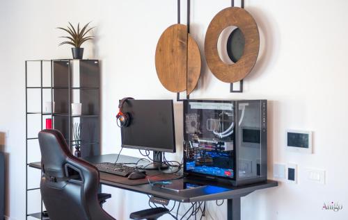 a desk with a computer and a monitor and a chair at Villa River in Mostar