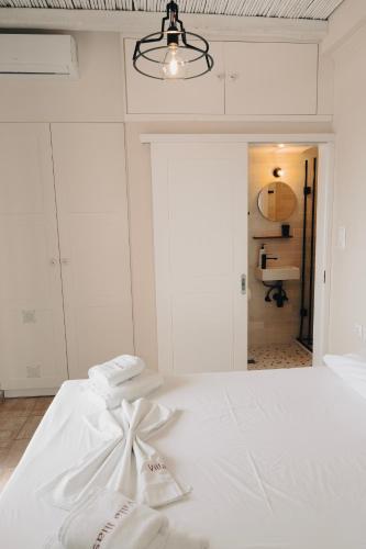 a bedroom with a white bed with a bow on it at Villa Ilias in Firostefani