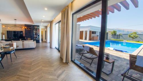 a living room with a view of a pool at Villa River in Mostar