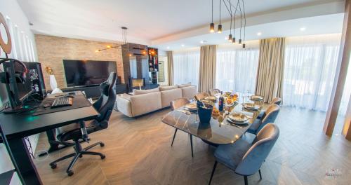 a living room with a table and chairs in a room at Villa River in Mostar