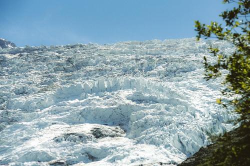 a large glacier with snow on a mountain at Big Sky Hotel & Spa in Chamonix-Mont-Blanc