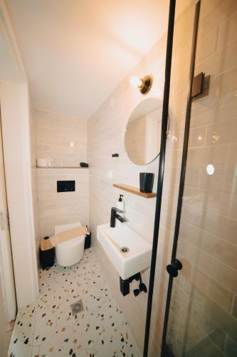 a bathroom with a sink and a toilet at Villa Ilias in Firostefani