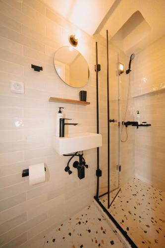 a bathroom with a sink and a shower at Villa Ilias in Firostefani