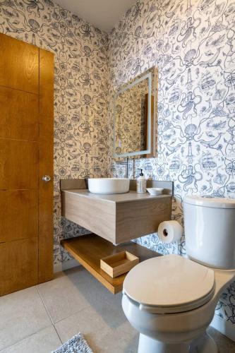 a bathroom with a toilet and a sink at Ocean Home Sweet Home - Suite 3 in Rosarito