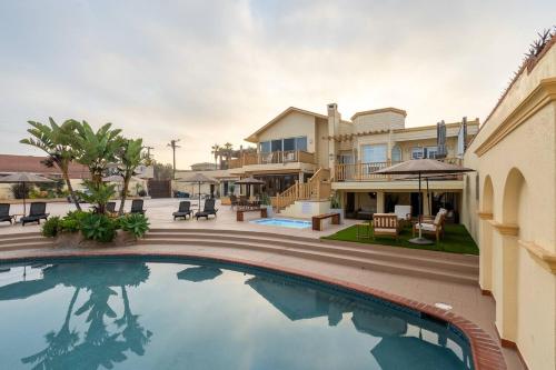 a swimming pool in front of a house at Ocean Home Sweet Home - Suite 3 in Rosarito