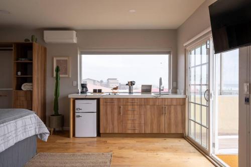 a kitchen with a sink and a large window at Entire Beach Home Away from Home in Rosarito
