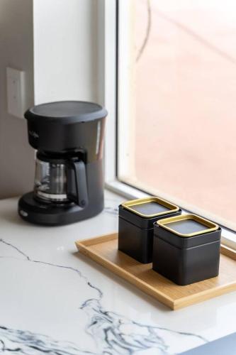 two black containers sitting on a cutting board next to a window at Entire Beach Home Away from Home in Rosarito
