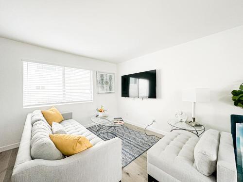 a living room with two white couches and a tv at Charming 2-BR, 2-Story Retreat in Heart of LA - BR4 in Los Angeles