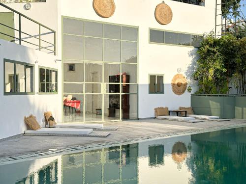 a house with a swimming pool next to a building at Villa Le Belvedere in Tangier