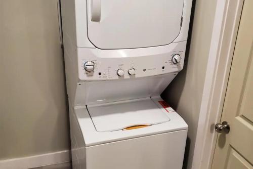 a washer and dryer sitting on top of a refrigerator at Gorgeous House & Loft Near Downtown in San Antonio