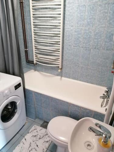 a small bathroom with a toilet and a sink at Cozy 1-bdrm apt in Dubec, ideal for work or study in Sesvete