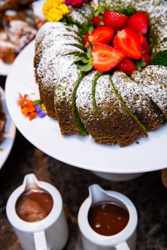 a cake on a plate with strawberries on it at VIP Executive Suites do Marquês Hotel in Lisbon