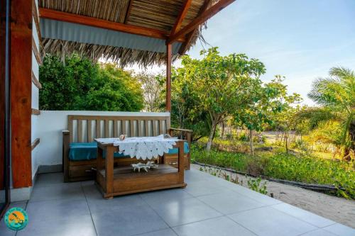 a porch with a table and a bench on it at Ny Fano Kite Lodge in Ivovona