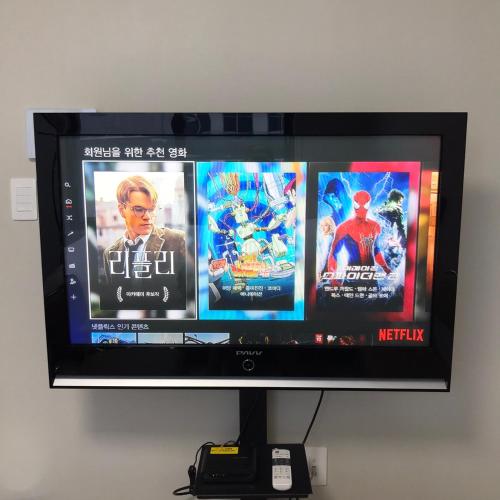 a flat screen tv with three movies on it at Tempus urban stay hotel in Daegu