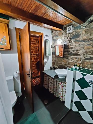 a stone bathroom with a sink and a toilet at Azoka by the River- Proença-a-Nova in Maljoga de Proença