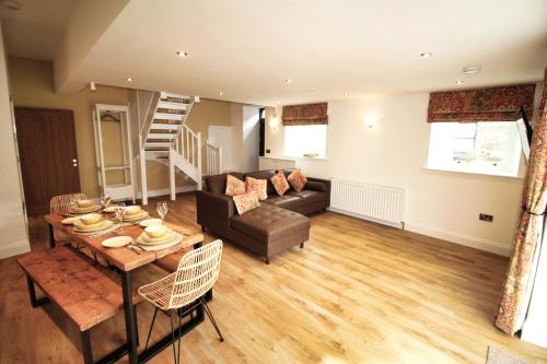 a living room with a couch and a table at Sleeps 4 - Town Centre - Very High End Renovation - Private Garden - Close to Train Station - Fast Wifi in Berwick-Upon-Tweed