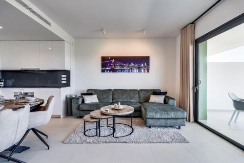 a living room with a couch and a table at Ultimate Rentals - Ipanema Del Sol - Relax With Scenic Views in Mijas