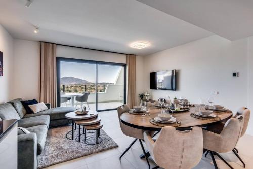 a living room with a table and a couch at Ultimate Rentals - Ipanema Del Sol - Relax With Scenic Views in Mijas