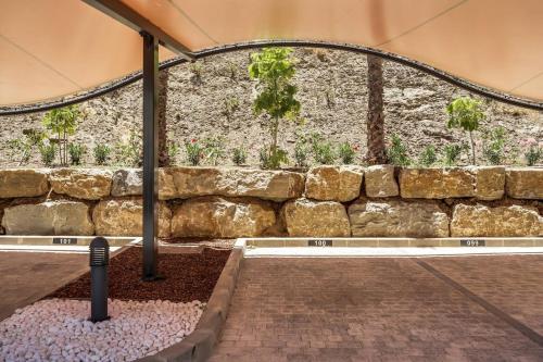 a stone wall with plants in front of it at Ultimate Rentals - Ipanema Del Sol - Relax With Scenic Views in Mijas