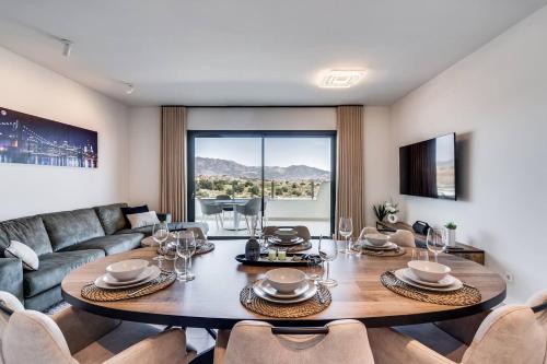 a living room with a table and a couch at Ultimate Rentals - Ipanema Del Sol - Relax With Scenic Views in Mijas